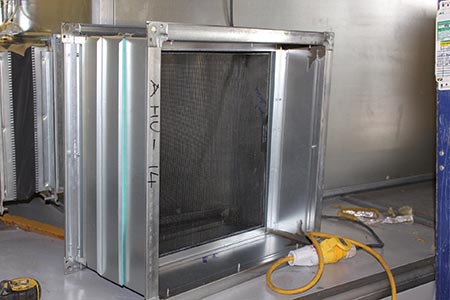 Air intake screens protect HVAC equipment against airborne debris